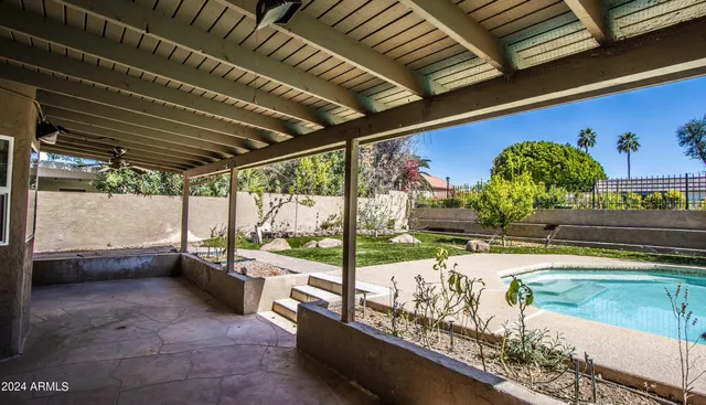 a swimming pool with outdoor seating