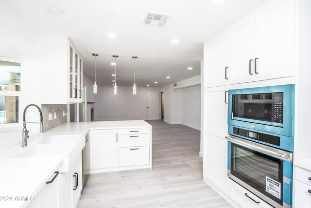a kitchen with kitchen island a sink stainless steel appliances and cabinets
