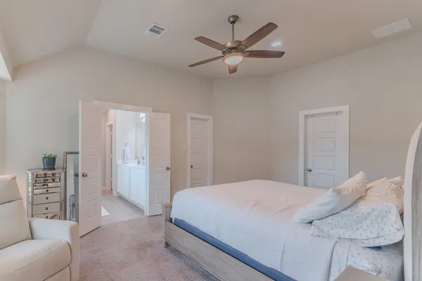 a bedroom with a large bed and a couch