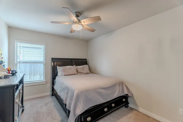 a bedroom with a bed and window