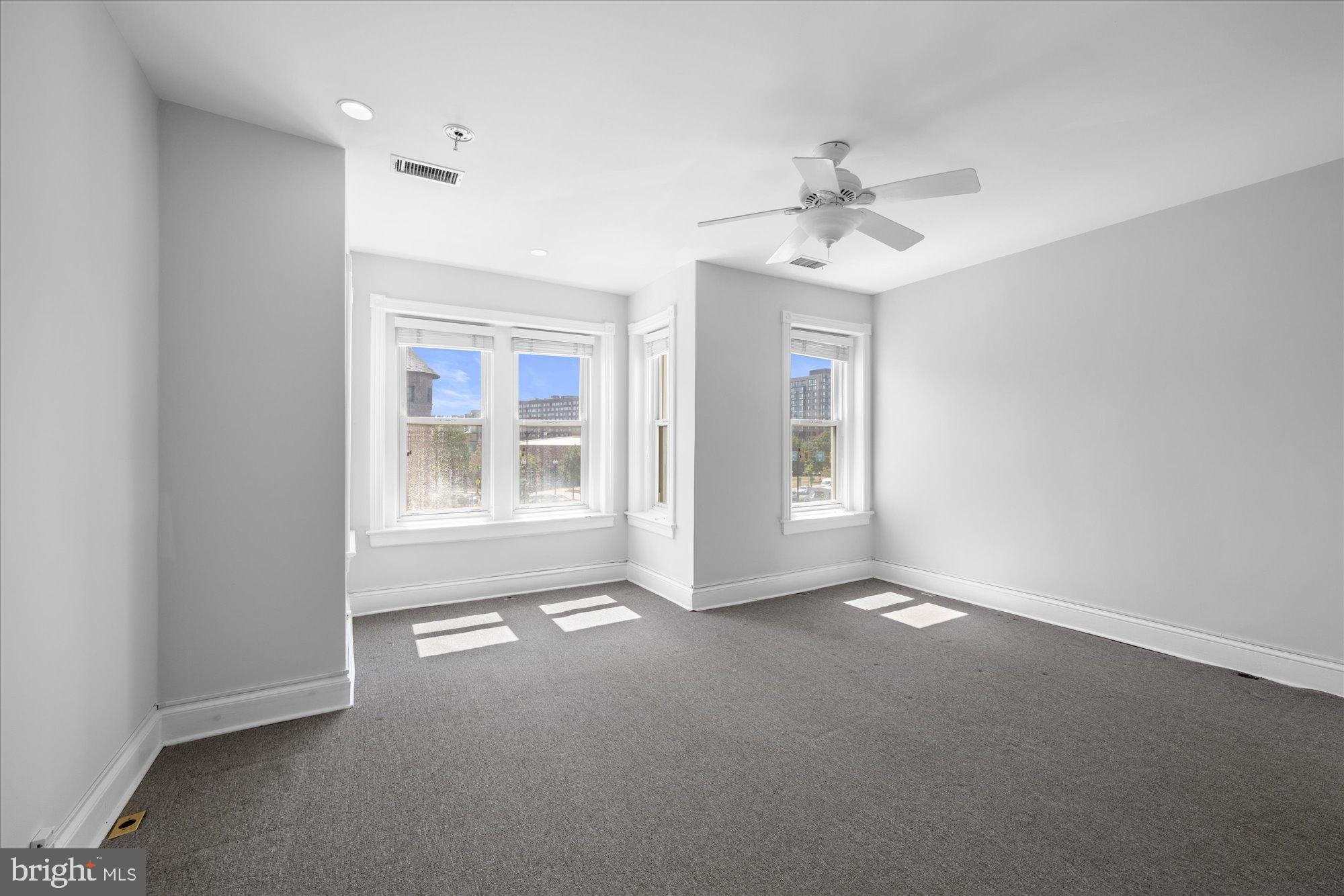 221 M Street Northwest Washington, DC 20001 - Photo 14 of 33 an empty room with windows and ceiling fan