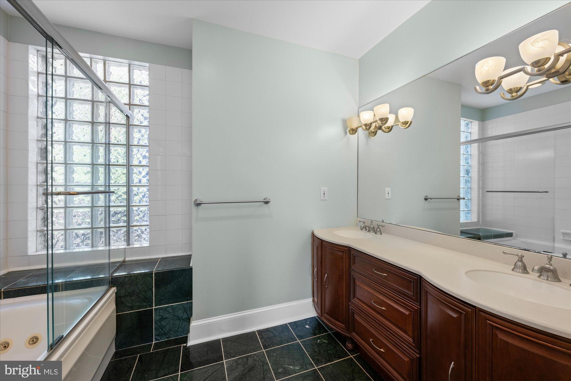 221 M Street Northwest Washington, DC 20001 - Photo 16 of 33 a spacious bathroom with a double vanity sink a large mirror and a bathtub