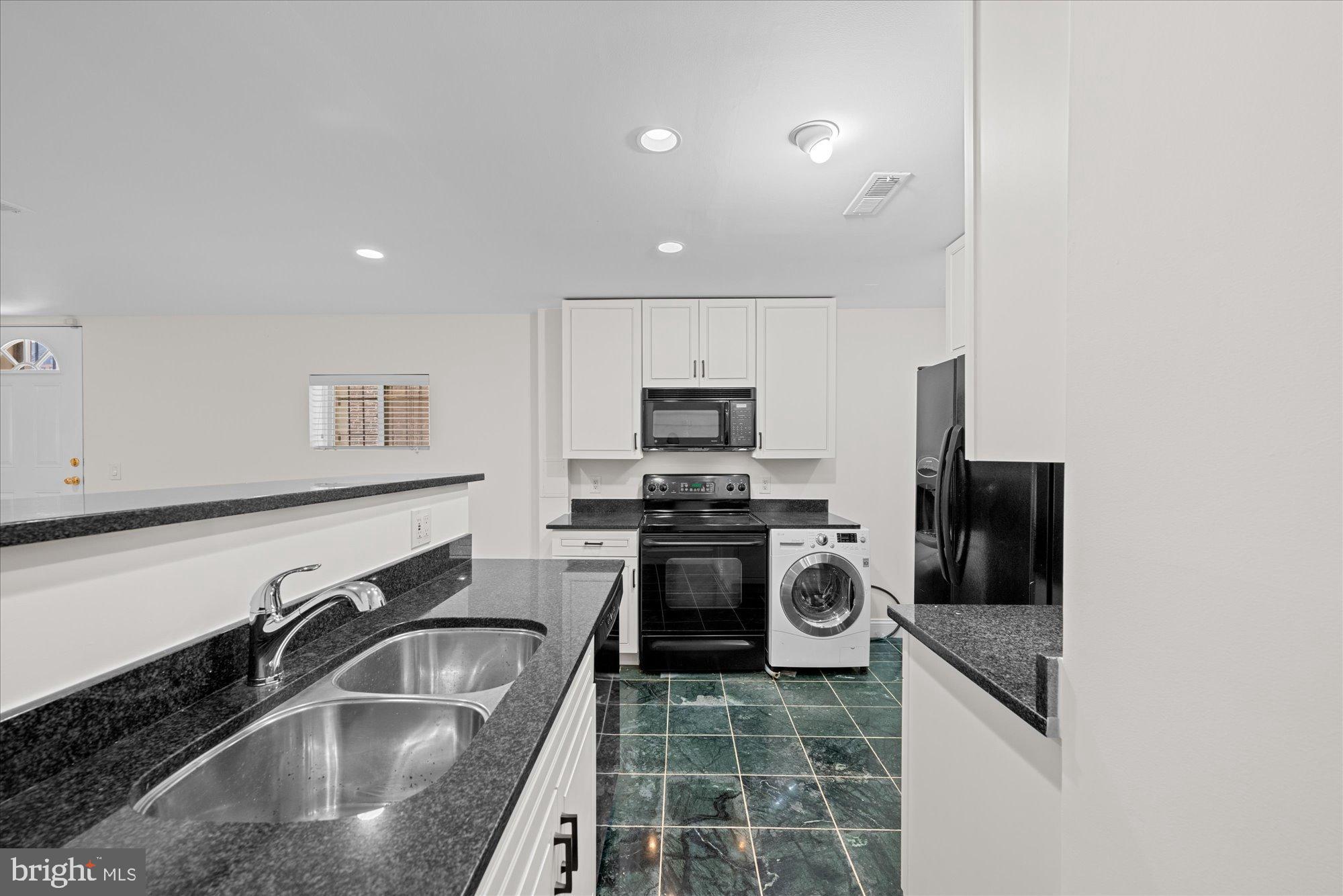 221 M Street Northwest Washington, DC 20001 - Photo 26 of 33 a kitchen with a sink microwave and refrigerator