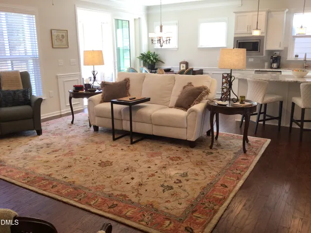 a living room with furniture a large window and a flat screen tv
