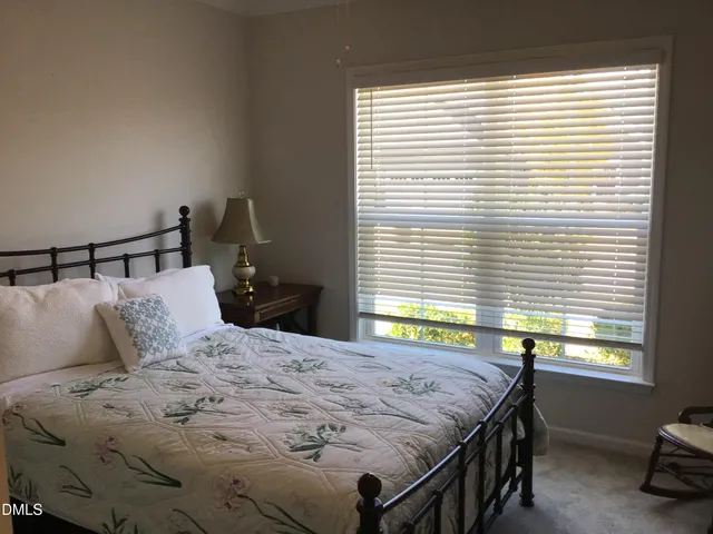 a front view of a house with a garden and parking