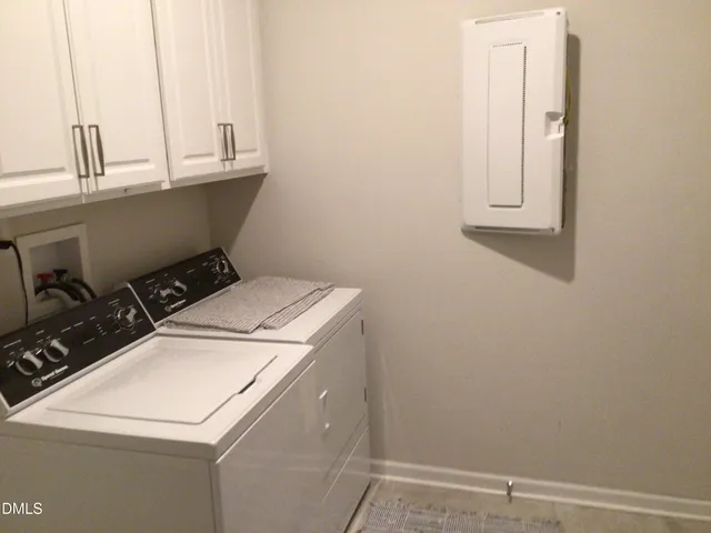 a living room with furniture and a book shelf
