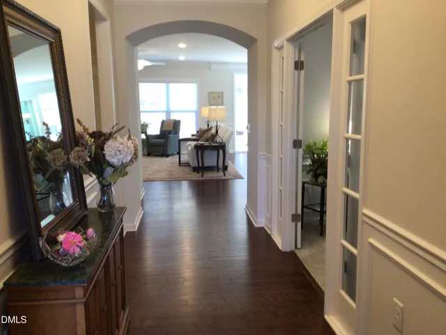a kitchen with stainless steel appliances granite countertop a sink a stove and chairs