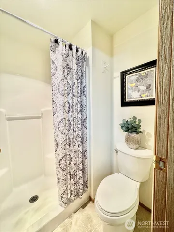 a white toilet sitting next to a bathroom sink