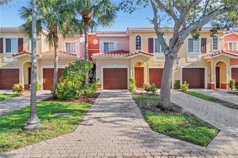 a front view of a house with yard and green space