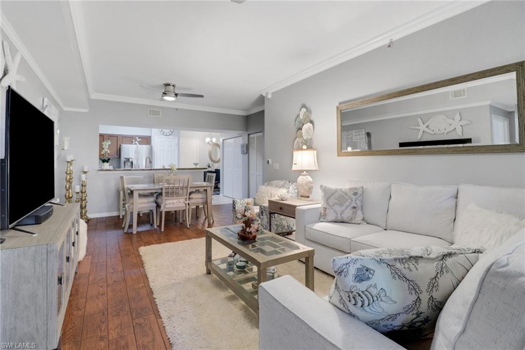 10126 Villagio Palms Way, Unit 107 Estero, FL 33928 - Photo 11 of 43 a living room with furniture and a flat screen tv