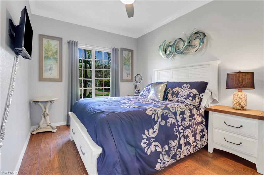 10126 Villagio Palms Way, Unit 107 Estero, FL 33928 - Photo 13 of 43 a bedroom with a bed and a flat screen tv