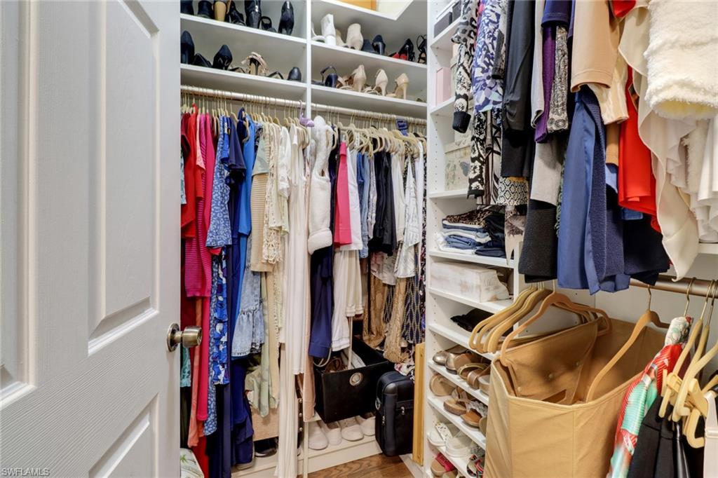 10126 Villagio Palms Way, Unit 107 Estero, FL 33928 - Photo 19 of 43 a view of walk in closet with clothes