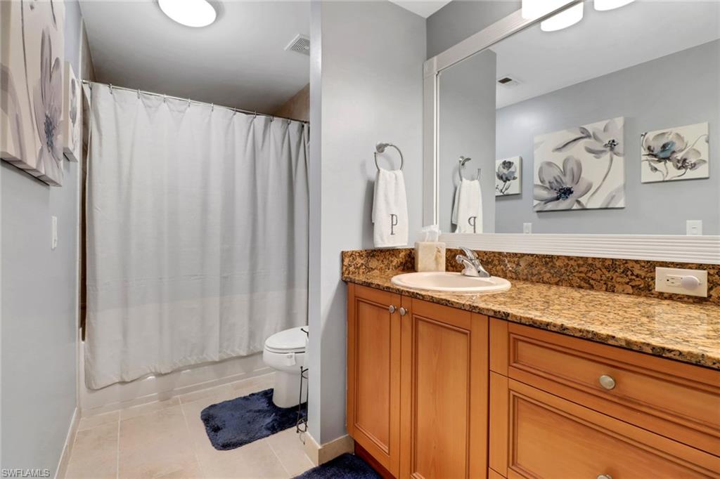 10126 Villagio Palms Way, Unit 107 Estero, FL 33928 - Photo 21 of 43 a bathroom with a sink a toilet and shower