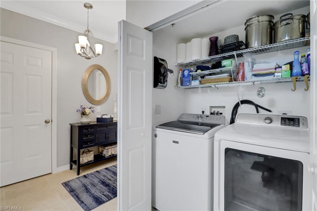 10126 Villagio Palms Way, Unit 107 Estero, FL 33928 - Photo 22 of 43 a kitchen with a sink a stove and cabinets