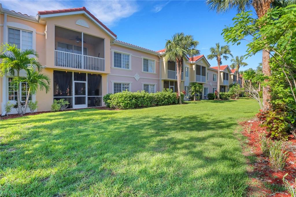 10126 Villagio Palms Way, Unit 107 Estero, FL 33928 - Photo 25 of 43 a front view of a building with a garden