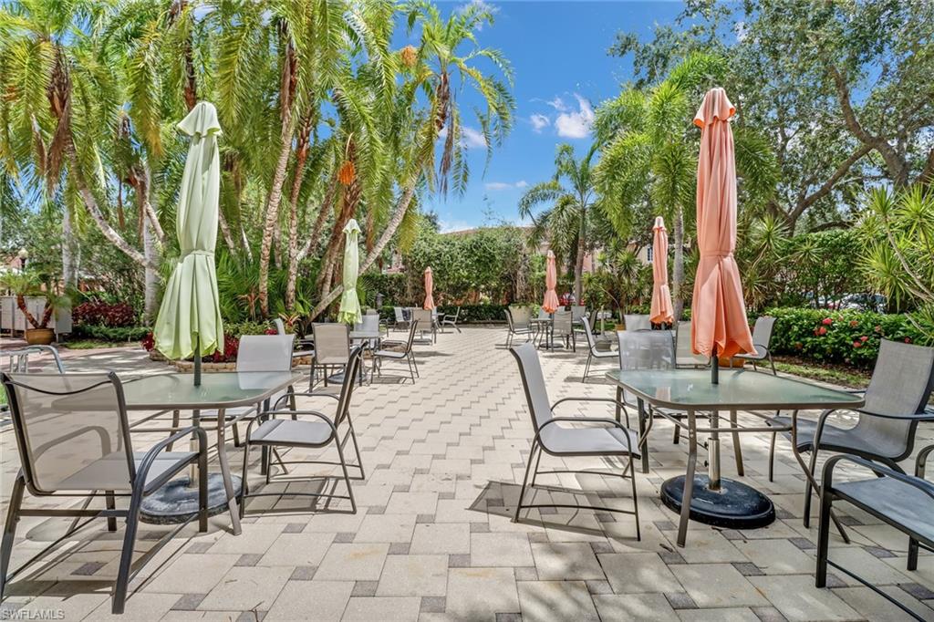 10126 Villagio Palms Way, Unit 107 Estero, FL 33928 - Photo 35 of 43 a view of a patio with chairs and tables