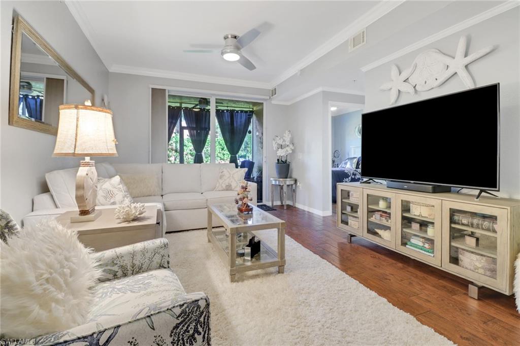 10126 Villagio Palms Way, Unit 107 Estero, FL 33928 - Photo 9 of 43 a living room with furniture and a flat screen tv