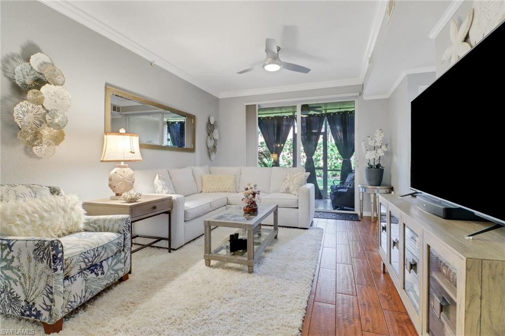 10126 Villagio Palms Way, Unit 107 Estero, FL 33928 - Photo 10 of 43 a living room with furniture and a flat screen tv