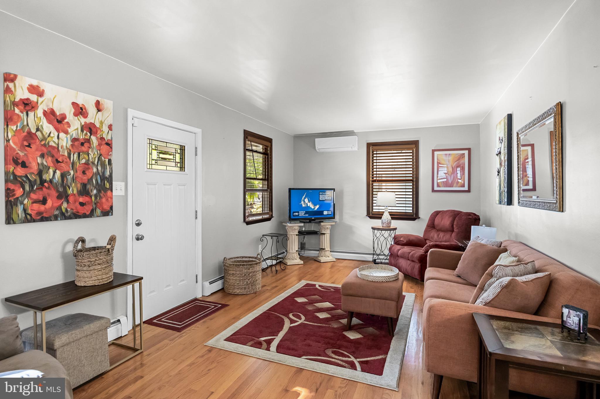 180 Cornell Road Audubon, NJ 08106 - Photo 8 of 38 a living room with furniture a flat screen tv and a wall painting
