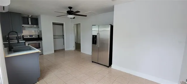 a view of a kitchen with a sink and a refrigerator