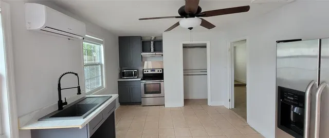 a kitchen with a refrigerator a sink and cabinets