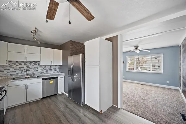 a kitchen with stainless steel appliances granite countertop a stove and a refrigerator