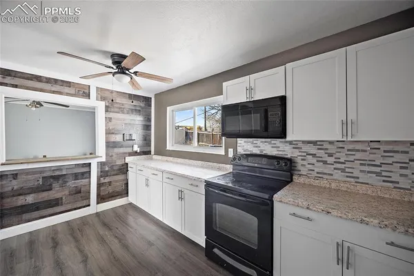 a kitchen with stainless steel appliances a stove sink and microwave
