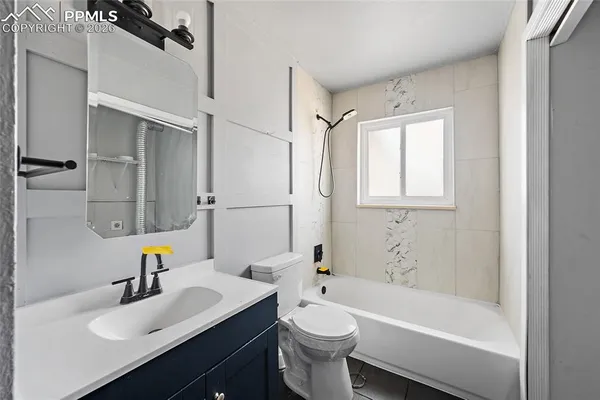 a bathroom with a sink mirror toilet and bathtub