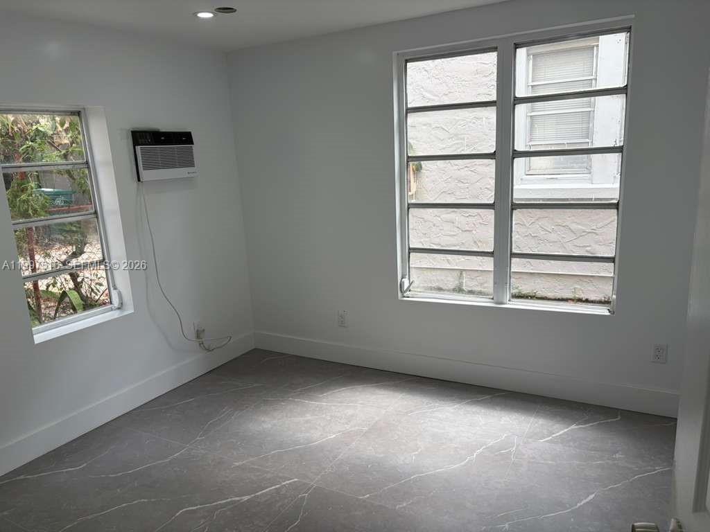 1011 Southwest 5th Street, Unit 1 Miami, FL 33130 - Photo 11 of 12 an empty room with a window