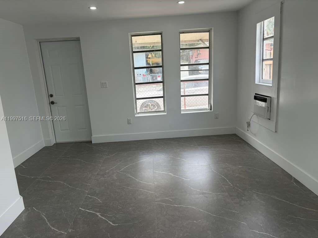 1011 Southwest 5th Street, Unit 1 Miami, FL 33130 - Photo 5 of 12 an empty room with windows