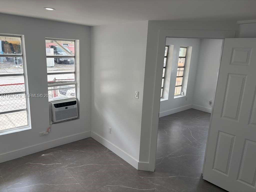 1011 Southwest 5th Street, Unit 1 Miami, FL 33130 - Photo 6 of 12 an empty room with windows and closet