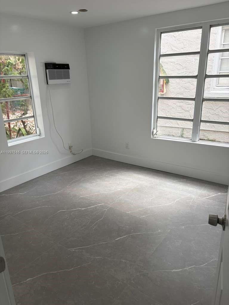 1011 Southwest 5th Street, Unit 1 Miami, FL 33130 - Photo 7 of 12 an empty room with a window