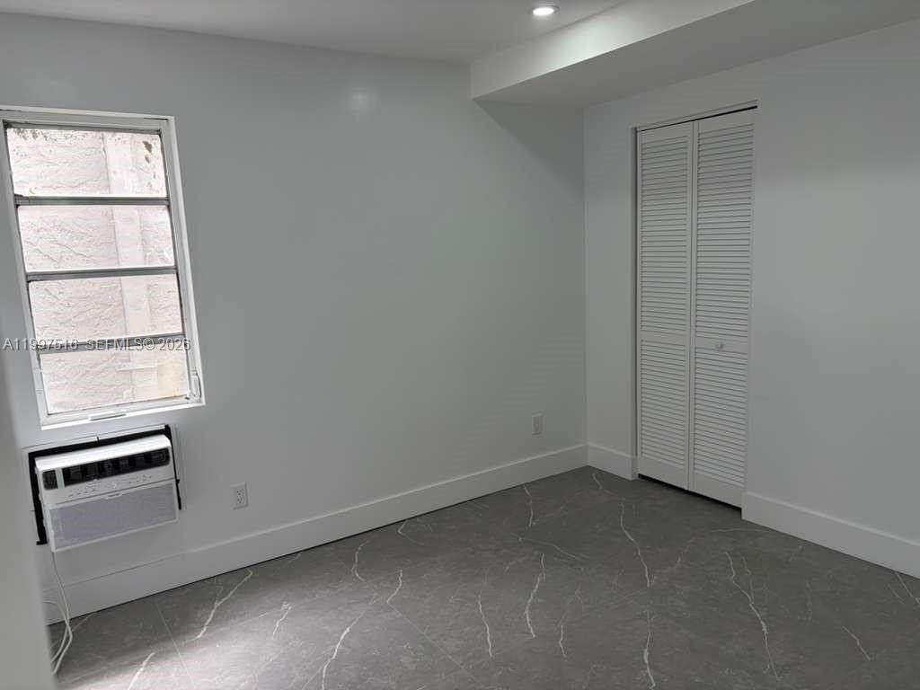 1011 Southwest 5th Street, Unit 1 Miami, FL 33130 - Photo 8 of 12 an empty room with a window