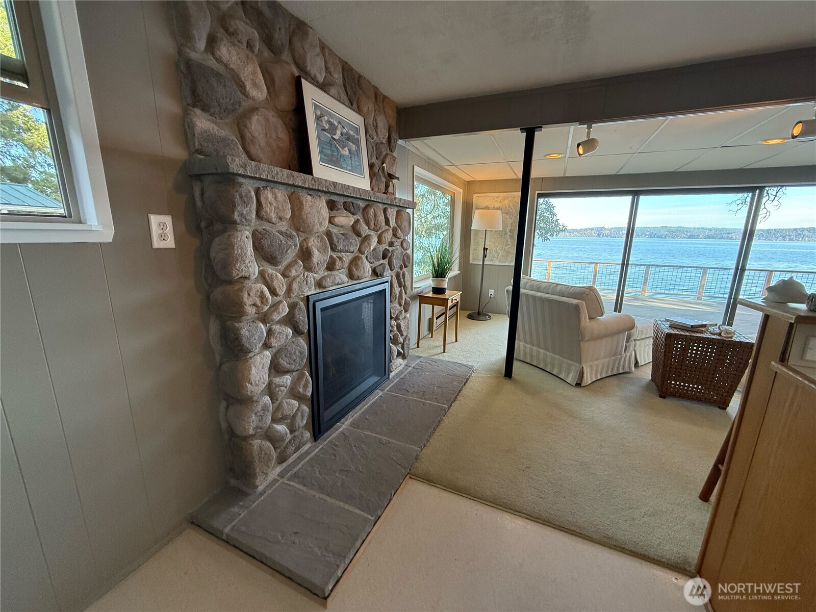 71 Seal Rock Road Brinnon, WA 98320 - Photo 9 of 22 a living room with furniture floor to ceiling window and a flat screen tv