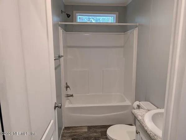 a bathroom with a toilet and a bath tub