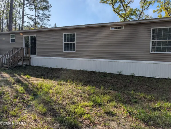 a side view of a house with a yard