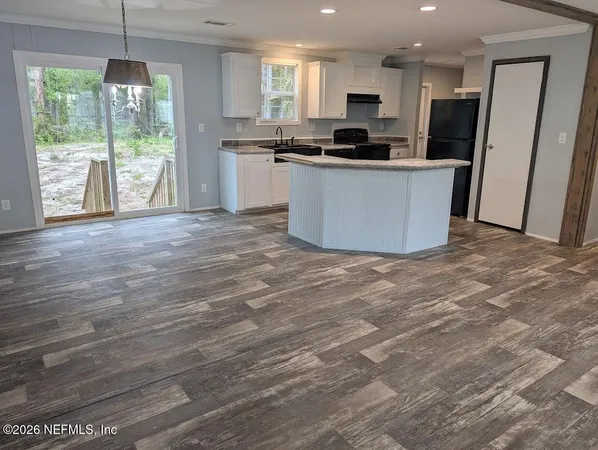 a kitchen with stainless steel appliances a stove top oven a sink and a refrigerator