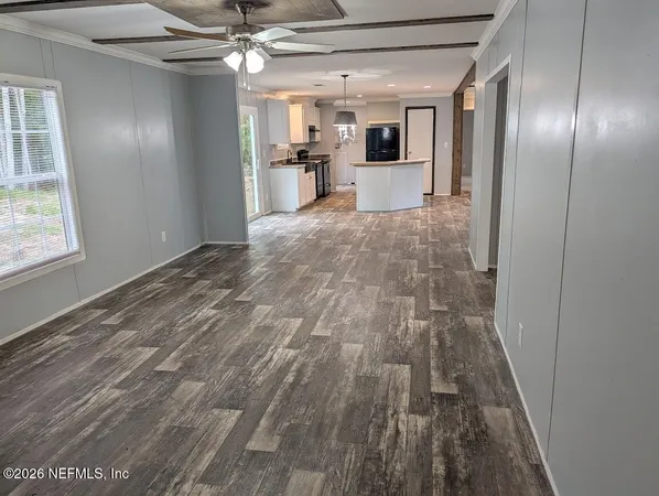 a view of empty room with wooden floor