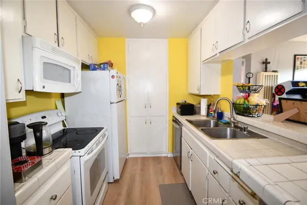 a kitchen with a sink stove and refrigerator