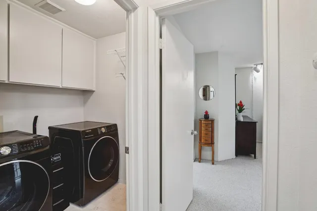 a view of a storage and utility room with washer and dryer