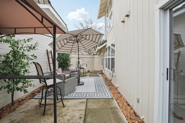 a view of a chairs and table in the balcony