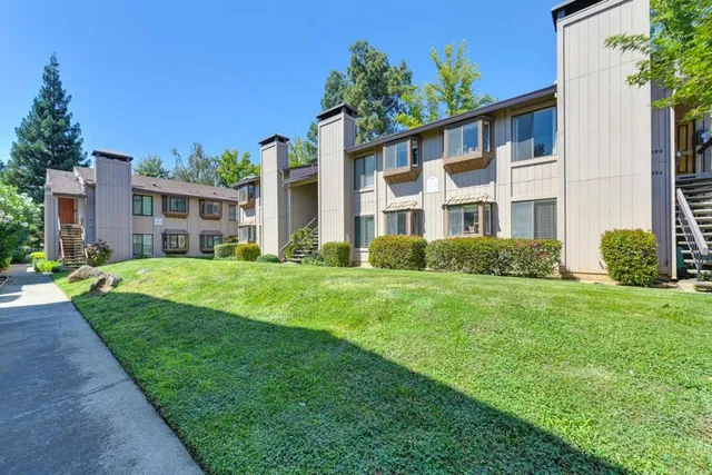 a front view of a house with a garden