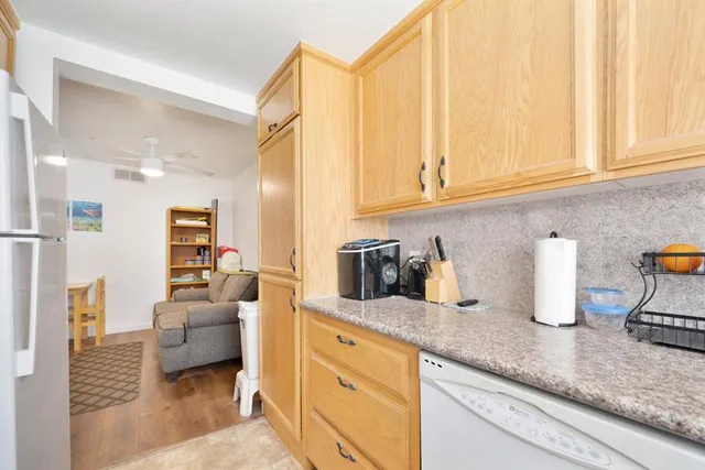 a kitchen with sink refrigerator and cabinets