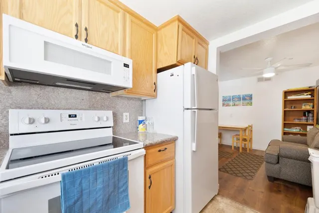 a kitchen with a refrigerator a stove a washer and dryer