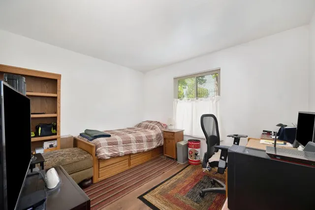 a living room with furniture a window and a flat screen tv