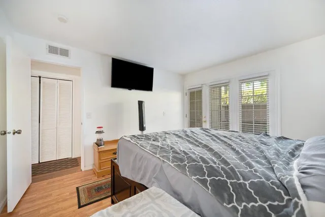 a bedroom with a bed and a flat screen tv