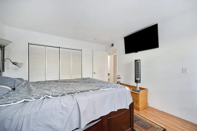 a bedroom with a bed and a flat screen tv