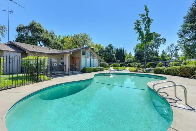 a view of a house with swimming pool and yard
