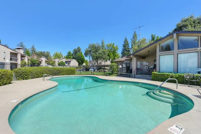 a view of a house with pool and a yard