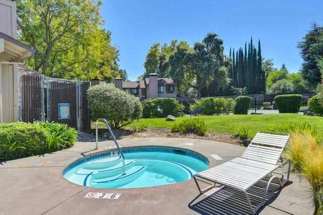 a swimming pool with barbeque oven outdoor seating and yard